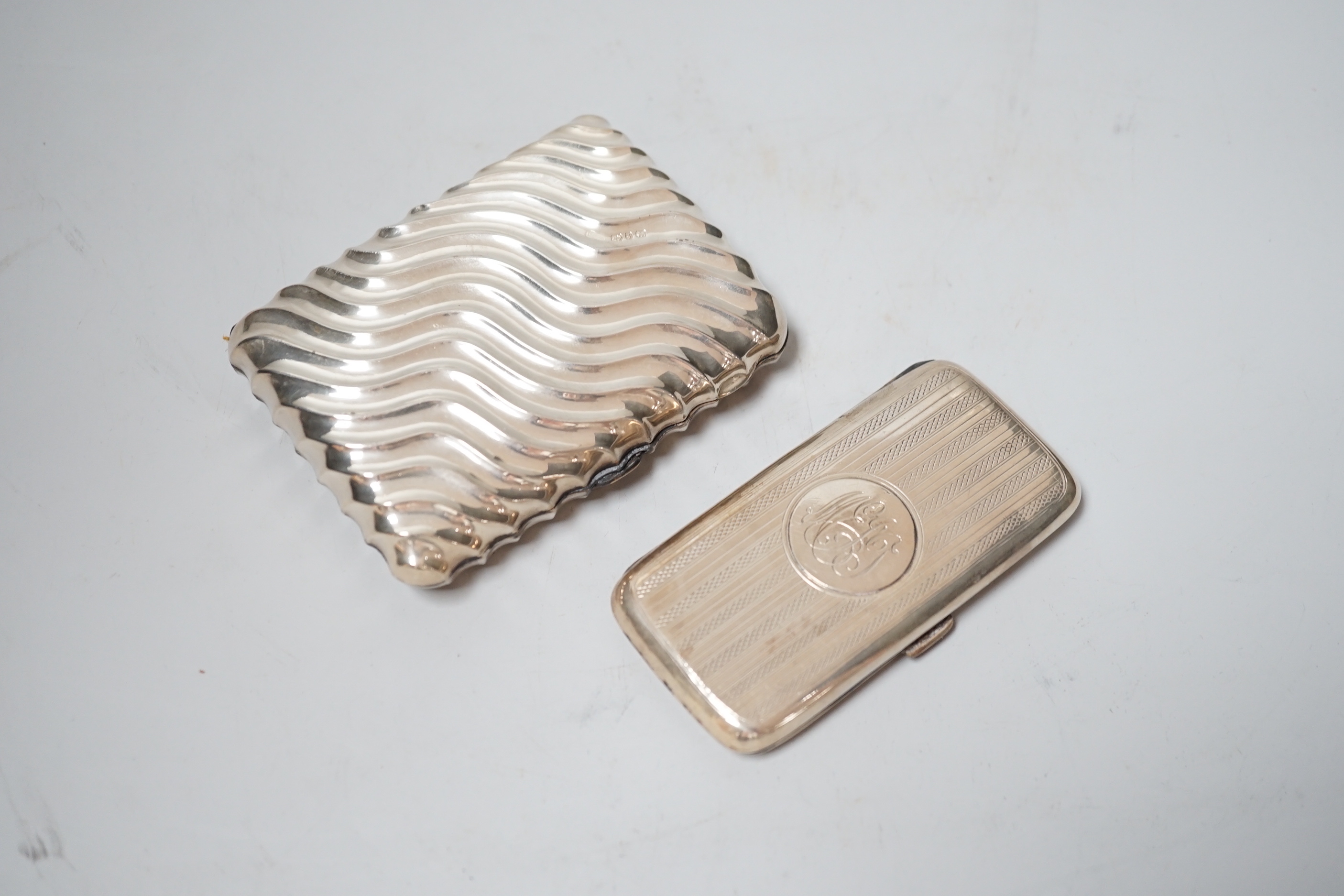 A late Victorian wrythened silver cigarette case, 88mm and a smaller silver cigarette case.